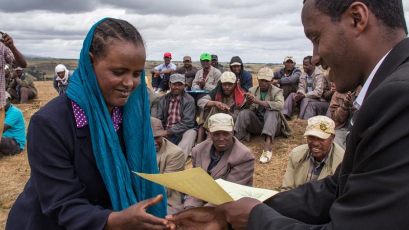 A farmer in Ethiopia receives a certificate after completing a course on wheat rust management